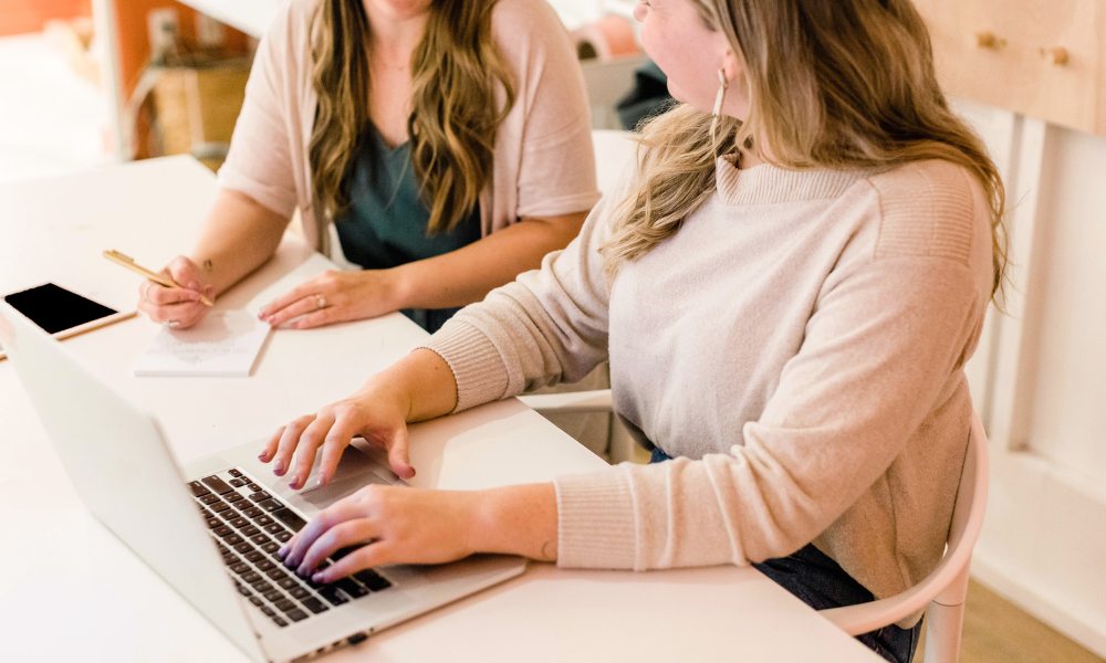 Female coaches working together on laptops