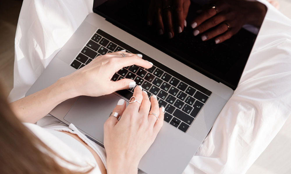 web designer hands typing on a laptop